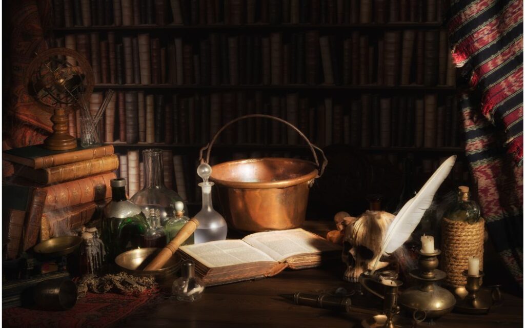 Tableau with copper pot, ancient leather book, herbs, feather pen illustrates Dark Academic Decor